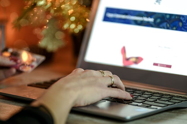 person looking at a website on a laptop